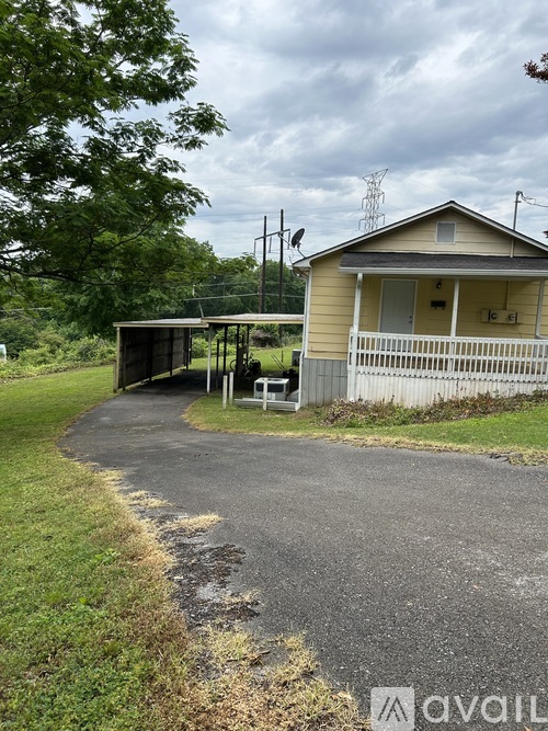 A house with a covered patio and a driveway.