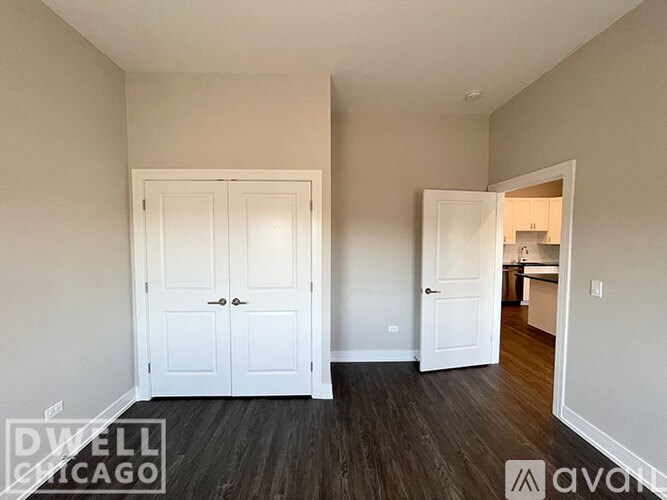 A room with a white door and a white cabinet.
