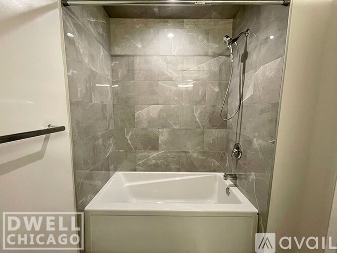 A white sink in a marble tiled bathroom.