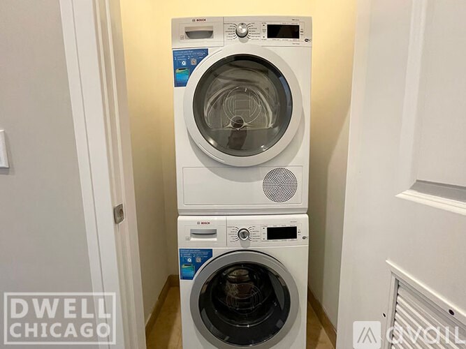 A white front load washing machine with a blue label on the door.