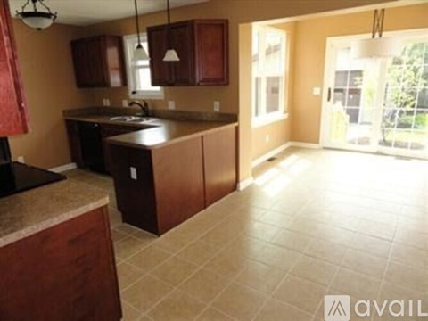 A kitchen with brown cabinets and a countertop.