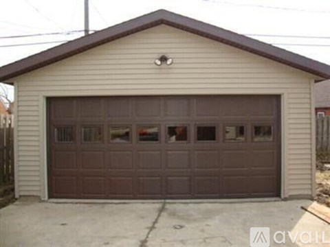 A two-car garage with a brown roof and siding.