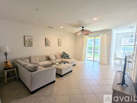 A living room with a large couch and a television.