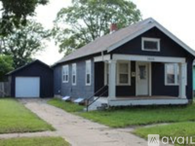 A black house with a white door and windows.