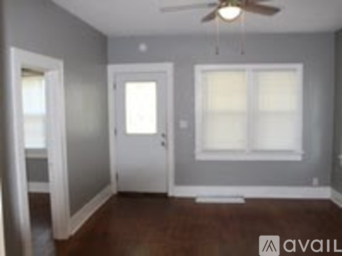 A room with a ceiling fan and a window.