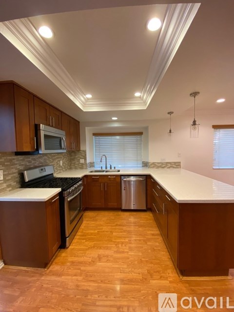 A kitchen with wooden cabinets and a white countertop.