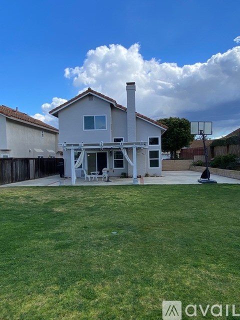 A house with a white exterior and a covered patio area.