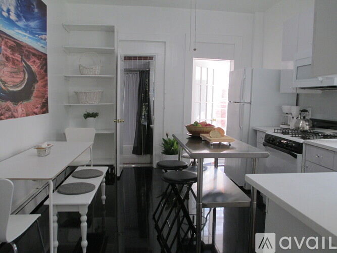 A kitchen with a table and chairs in front of a fridge and a stove.