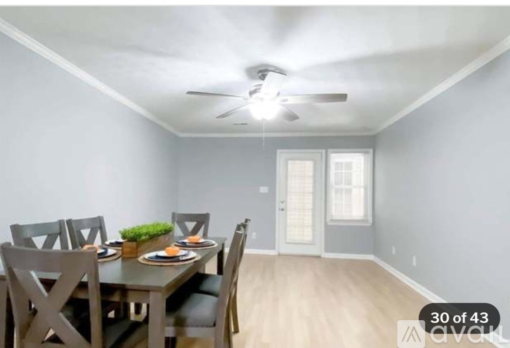 A dining room with a table set for four.