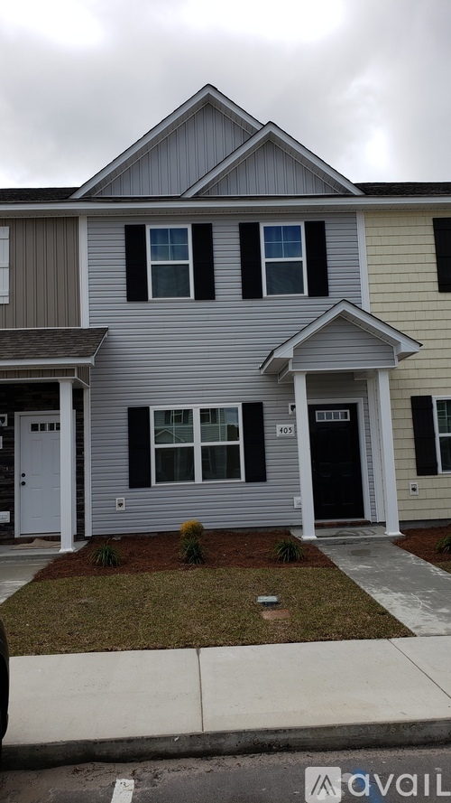 A two-story house with a grey and white exterior.