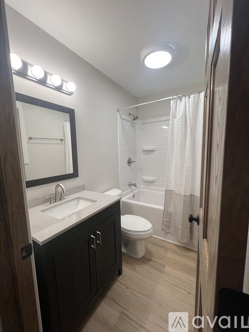 A bathroom with a sink, toilet, and shower.
