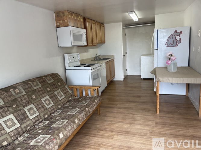 A kitchen with a white stove and microwave above it.
