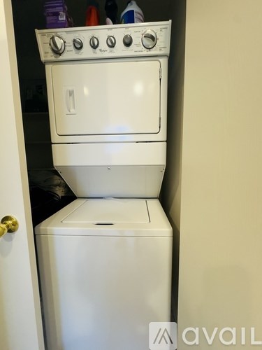 A white dishwasher and oven are stacked on top of each other.
