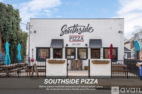 A white building with a sign that says "Southside Pizza" on it.