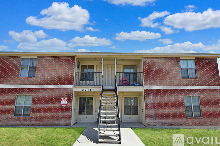 A red brick building with the number 2307 on the front door.