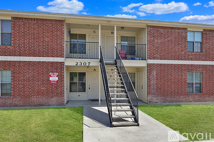 A red brick building with the number 3307 on the front door.