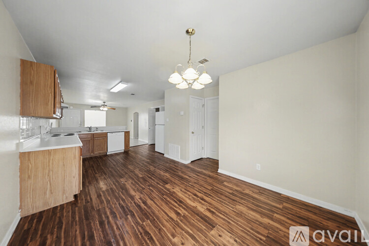 A spacious room with a ceiling fan and tiled flooring.