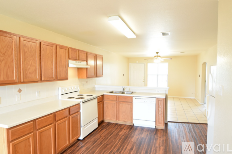 A kitchen with wooden cabinets and a white fridge.