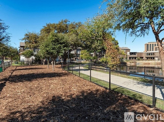 A room with a carpeted floor, a ceiling fan, and a door leading to a balcony.