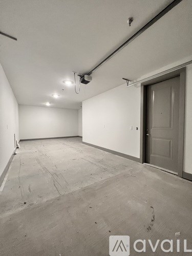 A room with a door and a wall-mounted projector.