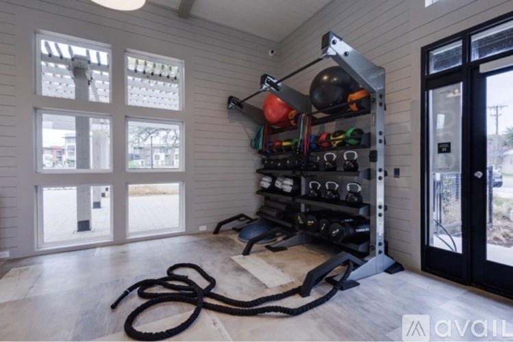A gym room with a pull up bar and weights.