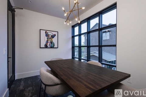 A modern dining room with a wooden table and chairs.