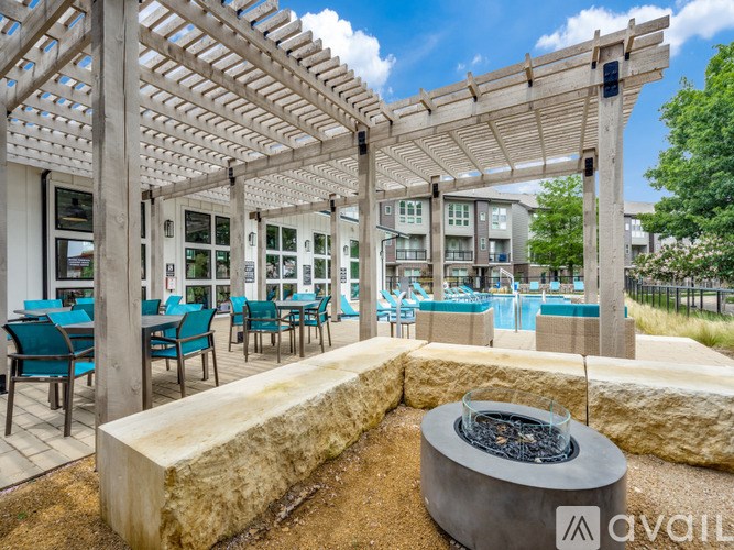 A patio area with a fire pit and seating area.