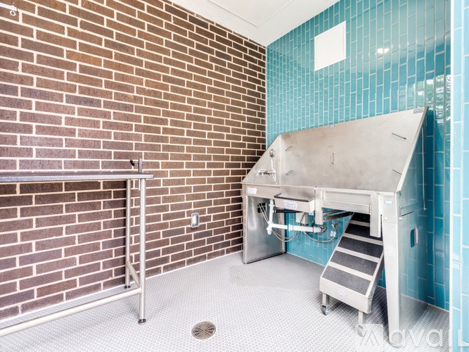 A brick wall with a metal staircase and a sink.