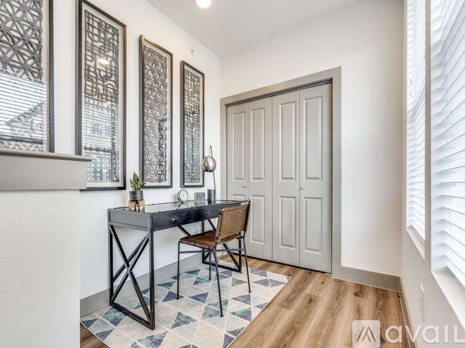 A room with a desk and chair in front of a door.