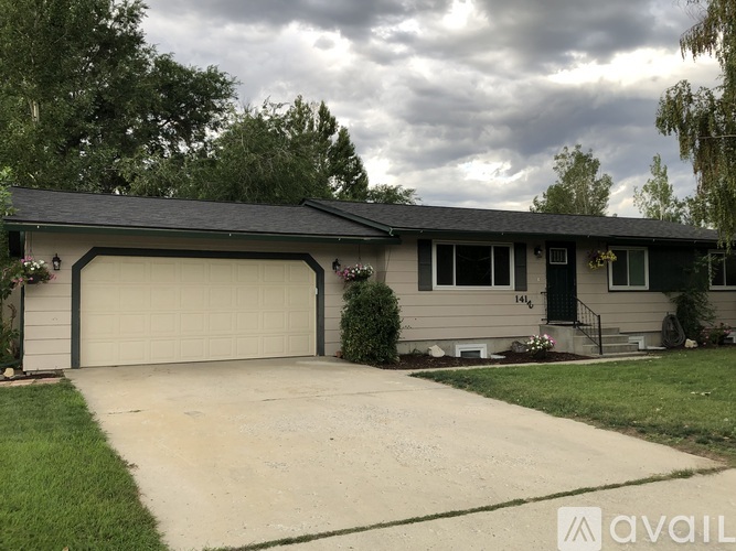 A house with a garage and a driveway in front.
