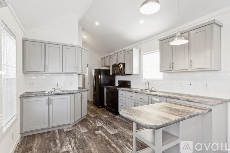 A kitchen with a wooden island in the middle.