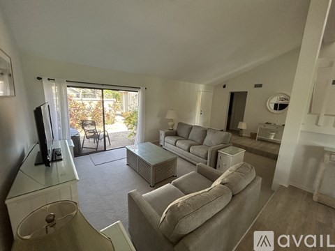 A living room with a grey couch and a television.