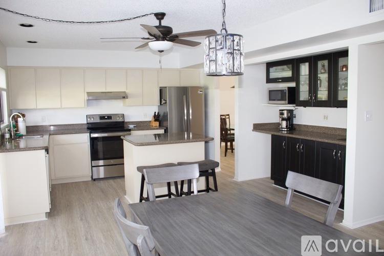 A modern kitchen with a dining table and chairs.