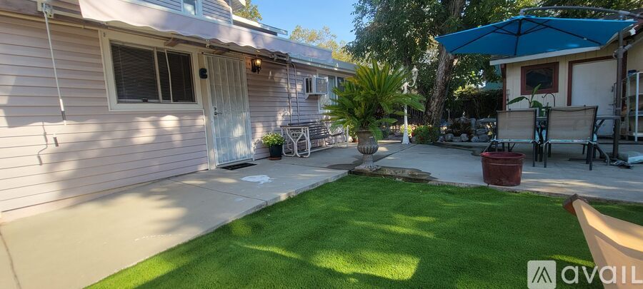 A backyard with a lawn and a patio area.