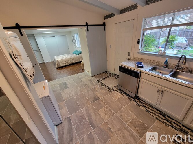 A kitchen with a sink, stove, and refrigerator.