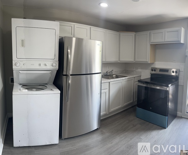 A kitchen with a stainless steel refrigerator, oven, and dishwasher.