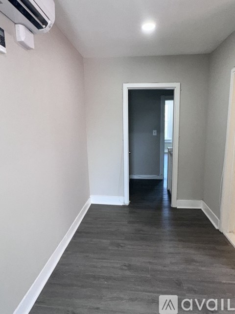 A room with a doorway leading to another room.