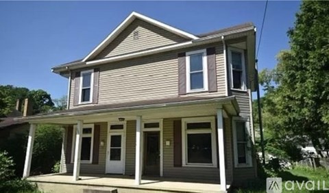 A house with a porch and a sign that says "available".