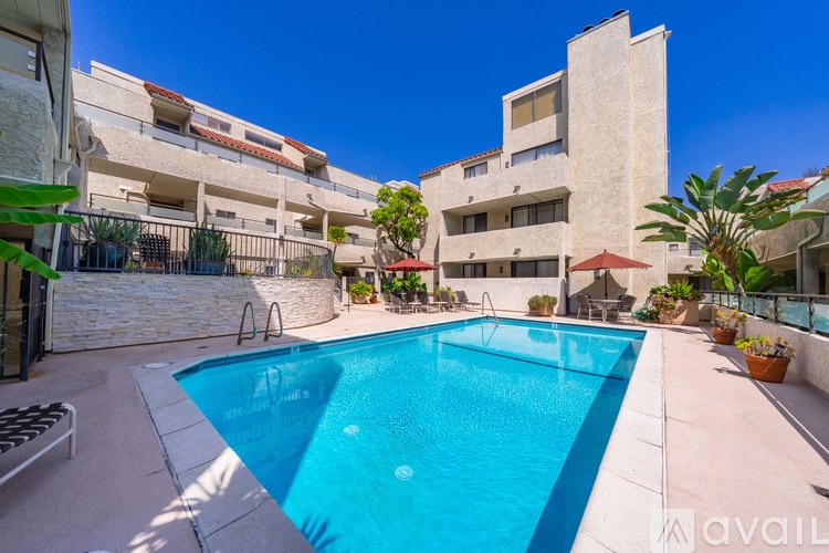 A swimming pool in a courtyard surrounded by buildings.
