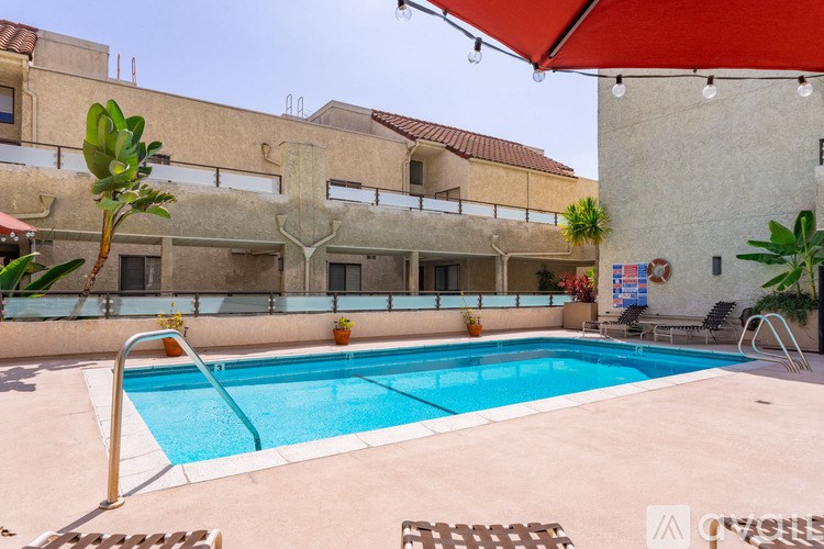 A pool in a courtyard surrounded by buildings.