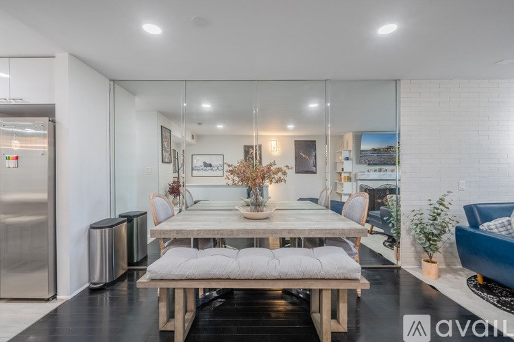 A modern dining room with a wooden table and bench.