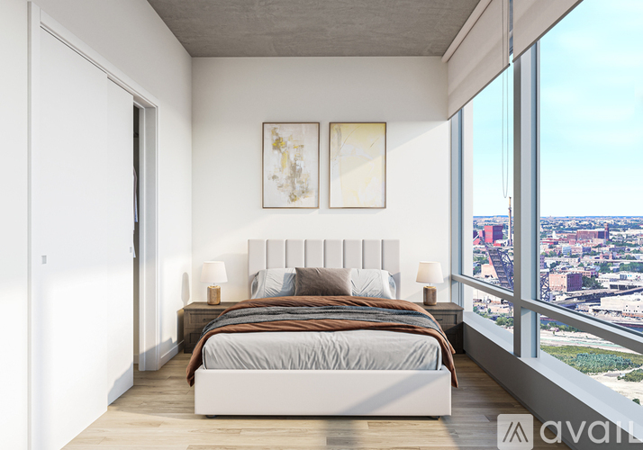 A bedroom with a large bed and a view of the city.