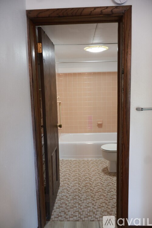 A bathroom with a toilet, tub, and sink.