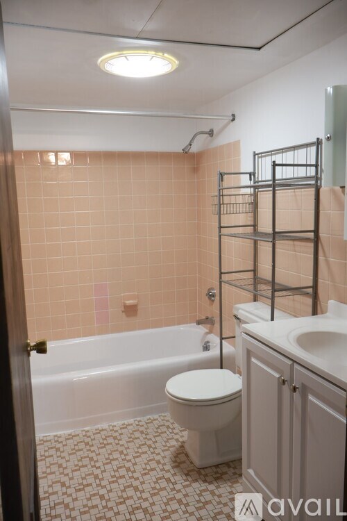 A bathroom with a toilet, sink, and bathtub.