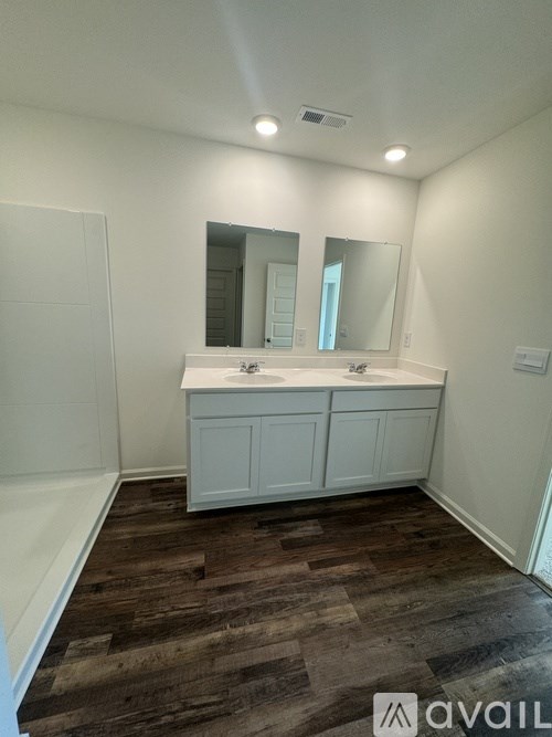 A bathroom with a vanity and a large mirror.