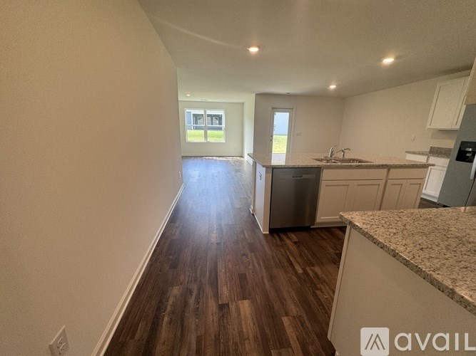 A kitchen with a refrigerator, sink, and cabinets is available for rent.