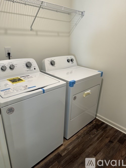 Two front loading washing machines in a laundry room.
