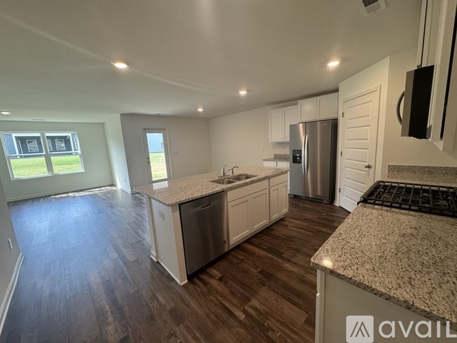 A kitchen with a granite countertop and stainless steel appliances.