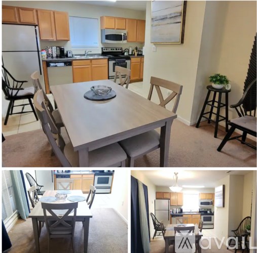 A kitchen with a table and chairs.