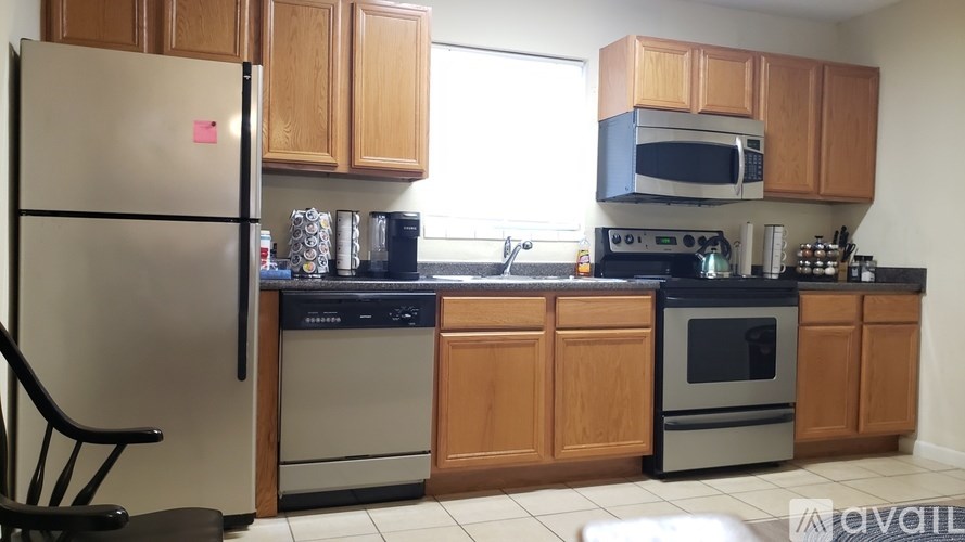 A kitchen with wooden cabinets and a white refrigerator.